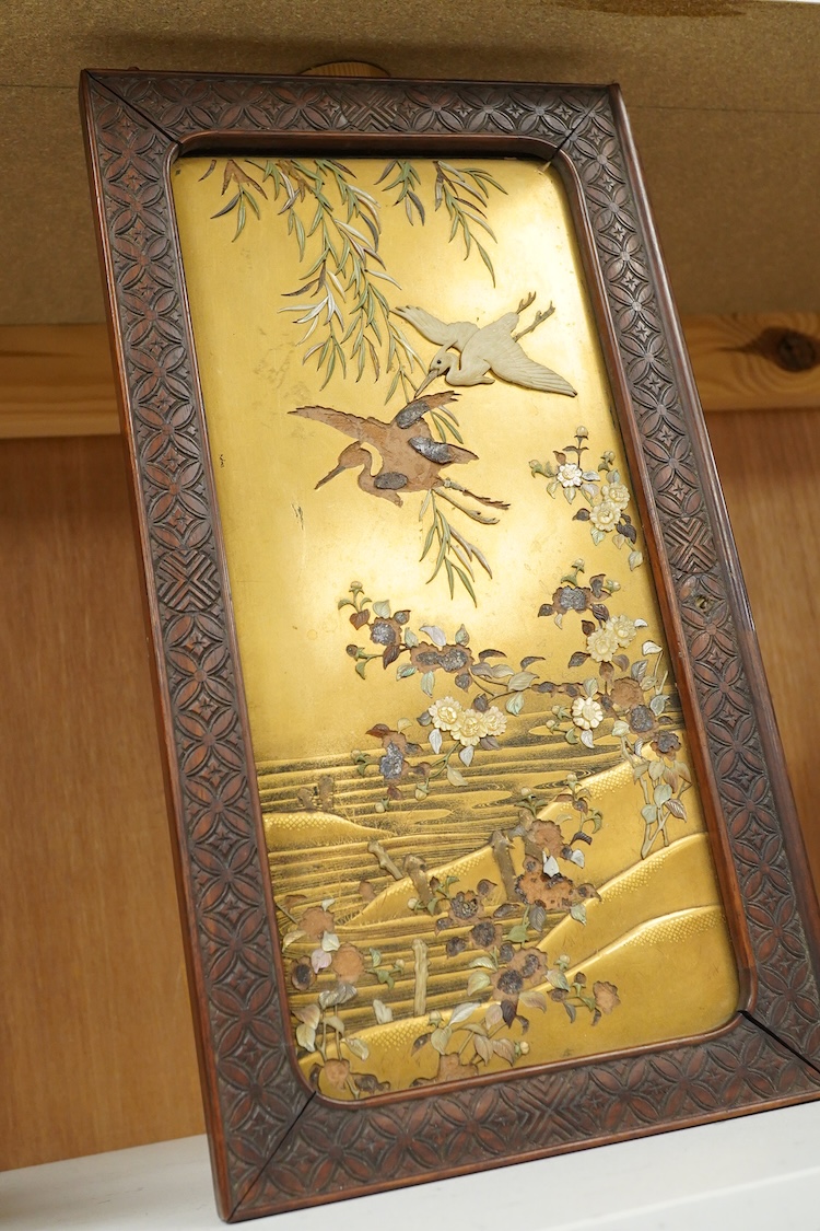A Japanese gold lacquer panel inlaid with a bone stork and flowers (some losses), framed, 34cm high